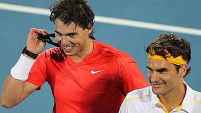 Rafael Nadal, left, and Switzerland's Roger Federer leave the court happy despite a tense final in Abu Dhabi.