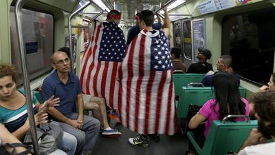 American soccer fans, Edward Amador, left, and Phillip Amador from Las Cruces, New Mexico, ride the subway on Sunday in Rio de Janeiro, Brazil. Their team plays Monday against Ghana. Joe Readle / Getty Images / June 15, 2014