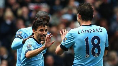 Jesus Navas of Manchester City and Frank Lampard of Manchester City celebrate after James Collins of West Ham (not pictured) scored an own goal during City's Premier League win on Sunday. Clive Brunskill / Getty Images / April 19, 2015
