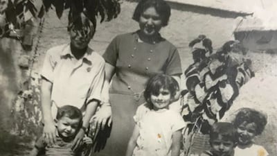 Majida Obaid, in the centre dressed in white, with her mother and siblings when they lived in the British camp in Sharjah in 1972. All photos: Majida Obaid