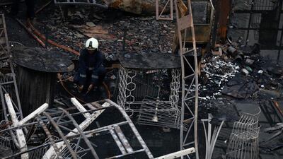 A firefighter goes through the debris of the restaurant. Danish Siddiqui / Reuters