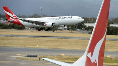 A Qantas flight landing at Adelaide airport. AFP PHOTO / Saeed KHAN