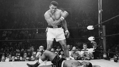 Muhammad Ali stands over challenger Sonny Liston in Lewiston, Maine, in 1965. John Rooney / AP Photo