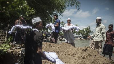 Bangladeshi people bury the bodies of Rohingya Muslim refugees at the pier of Shah Porir Dwip Island near Teknaf. Fred Dufour / AFP
