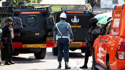 Armed police and military personnel stand guard after an explosion at a school complex in Jakarta. Reuters