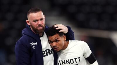 Wayne Rooney with Duane Holmes after the match. PA