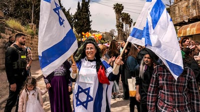 Orit Malka Strock, Israel's Minister of Settlements and National Missions, centre, stands with settlers in the divided West Bank city of Hebron on Sunday. The settler movement has moved from the fringes of Israeli politics to the heart of government. AFP