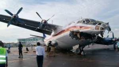 Security personnel stand near a Aero Service Antonov 12 cargo plane that hit a Canadian Airways Boeing 727 last year in the Congo.