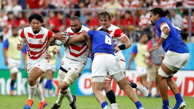 Japan's Michael Leitch runs at Samoa's Jack Lam during the Rugby World Cup Pool A match. Associated Press