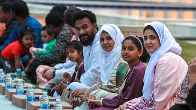 Worshippers wait for the start of iftar at the mosque. Victor Besa / The National