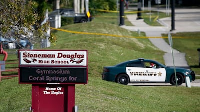 Law enforcement officers block off the entrance to Marjory Stoneman Douglas High School on February 15, 2018 in Parkland, Florida, following a deadly shooting at the school. AP