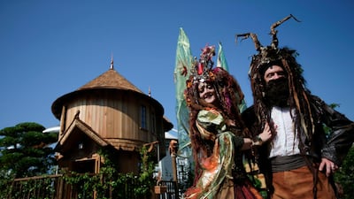 Performers pose in front of the Blue Forest Tree Houses.