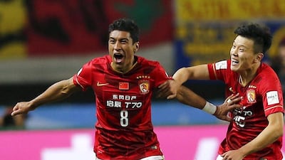 Guangzhou Evergrande midfielder Paulinho, left, celebrates his winner against Mexican club America in the Club World Cup in Osaka, Japan. Thomas Peter / Reuters