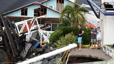Locals inspecting the damage to the marina at Shute Harbour near Airlie Beach, Queensland. Emergency crews also began assessing the damage but blocked roads and flash flooding hampered effort. Dan Paled/EPA