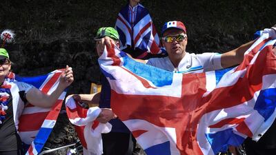 Spectators wave the Union Jack during the 10th stage of the Tour de France between Annecy and Le Grand-Bornand. Jeff Pachoud / AFP