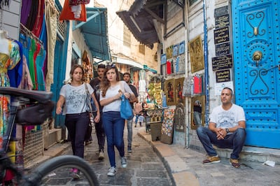 Shoppers pass through the narrow alleys in the souks of the Medina in Tunis. Getty Images