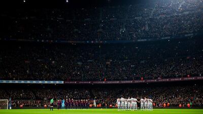 Players of Barcelona and Atletico de Madrid observe a minute of silence in memory of the victims of terrorist attacks in Paris, France before their La Liga match on Sunday. Alex Caparros / Getty Images