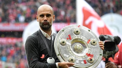 Bayern Munich manager Pep Guardiola poses with the Meisterschale as he celebrates the Bundesliga champions after his team topped Hannover 96 at Allianz Arena on May 14, 2016 in Munich, Germany. Matthias Hangst/Bongarts