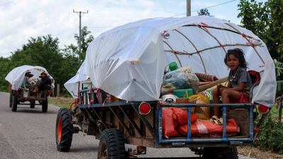 Residents in Oddar Meanchey province, north-west Cambodia, head back towards the border area with Thailand, after the countries agreed to a truce following five days of fierce fighting. Reuters