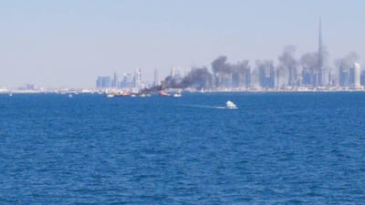 Firefighters aboard specialised boats tackle the blaze off the coast of Dubai. The National