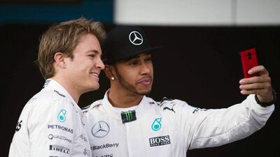 Mercedes drivers Nico Rosberg, left, and Lewis Hamilton, right, share a picture during F1 winter testing at Jerez racetrack in Spain on Sunday. Jorge Zapata / EPA