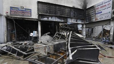Four workshops are damaged by a fire in Umm Ramool industrial area in Dubai. Jeffrey E Biteng / The National