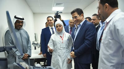 Syrian Minister of Health Hassan Al Ghabbash, centre right, and Emirati charge d'affaires Abdul Hakeem Al Nuaimi, left, listen to a doctor during the opening ceremony of the UAE-funded Sheikh Mohamed bin Zayed Field Hospital in Aleppo. AFP