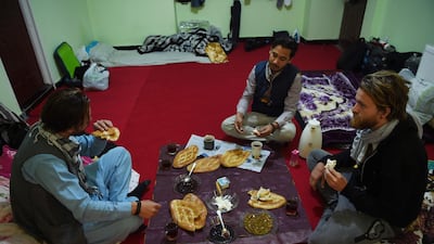Afghan Couchsurfing host eats brekfast with his guests Norwegian tourist Jorn Bjorn Augestad, 29, and Dutch tourist Ciaran Barr, 24. AFP