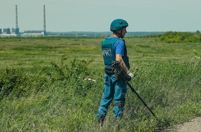 An emergency serviceman of the self-proclaimed Donetsk People's Republic demining a road in front of the coal-fuelled thermal power station in Vuhlehirska. EPA.