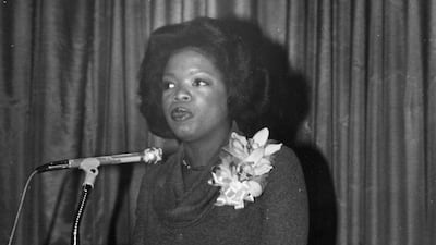 Oprah Winfrey wears a floral brooch to speak at a podium early in her career, during her time at WJZ, Baltimore, Maryland on January 20, 1978. Getty Images