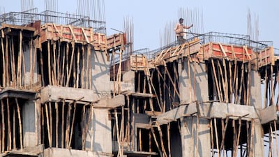 An Indian labourer at a construction site in Mumbai. Nearly a third of developers’ housing inventory is usually sold during festive sesaons. Divyakant Solanki / EPA