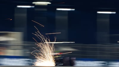 Sparks fly behind Zhou Guanyu of China driving the Alfa Romeo during practice. Getty Images