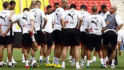Coach Rabah Saadane, right, talks to the Algeria squad during training in Luanda.
