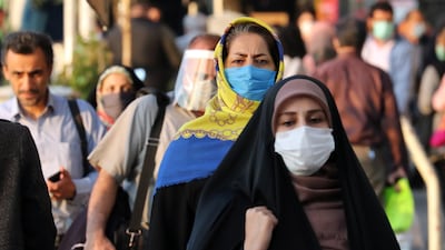 Iranians wearing face masks walk on a street in Tehran, Iran, 19 October 2020. EPA