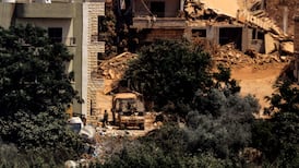 Israeli humvees stationed between houses in southern Lebanon. AFP