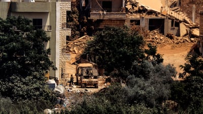 This picture taken from the southern Lebanese village of Zawtar al-Gharbiyah shows Israeli humvees stationed between houses in the nearby village of Zawtar al-Charkiyah on August 13, 2026. Lebanese Prime Minister Nawaf Salam on August 12 condemned Israel's "systematic destruction" in the country's south as a violation of international law, as Israel's defence minister said its military was "destroying all the houses" there. (Photo by Ammar Ammar / AFP) /