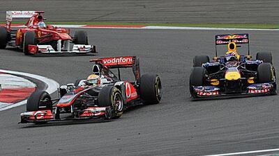 Lewis Hamilton, centre, held off the challenge of Fernando Alonso, left, and Mark Webber to win the German Grand Prix.