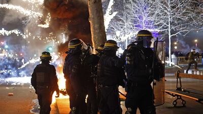 Fireworks explode as French riot police stand guard at Republique square during a demonstration against the government pension reform in Paris. EPA