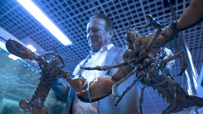 Jurgen Scharkosi, the general manager of The Big Blu, with two Canadian Lobsters flown in from Nova Scotia. Mr Scharkosi relies on air freight for 95 per cent of his business. Silvia Razgova / The National