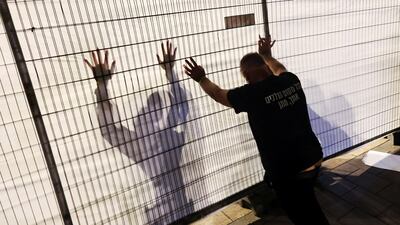 A demonstrator attempts to knock down a barrier during a protest demanding the immediate release of hostages, outside Israeli Prime Minister Benjamin Netanyahu's residence in Jerusalem. Reuters