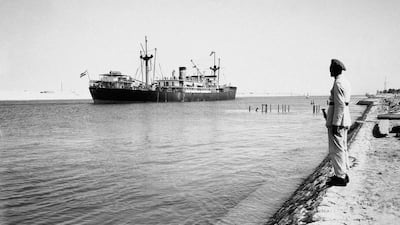 A soldier stands guard as the Argentine cargo ship Mabel Ryan sails through the Suez Canal south to the city of Suez, in 1956. AP Photo