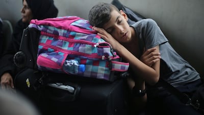 A Palestinian boy sleeps as he waits with his family for a travel permit to cross into Egypt through the Rafah border crossing after it was opened by Egyptian authorities for humanitarian cases, in Rafah in the southern Gaza Strip August 16, 2017. Ibraheem Abu Mustafa / Reuters