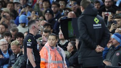 Referee Chris Kavanagh looks at the pitchside monitor before awarding Manchester City a penalty. AFP