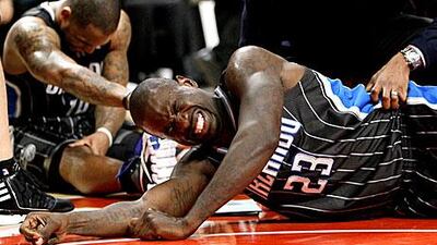 Orlando Magic guard Jason Richardson (23) grimaces as teammate Jameer Nelson recovers after a play during the second half.