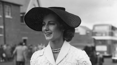 Model Fiona Campbell-Walter, as known as Baroness Thyssen-Bornemisza, wears a black straw hat and a white corded suit in 1953. Getty Images