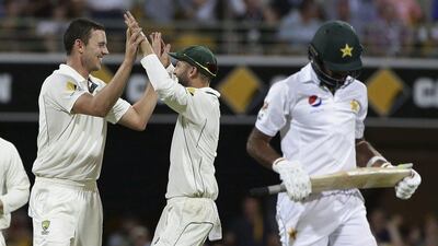 Australia's Josh Hazlewood, left, is congratulated by teammate Nathan Lyon after dismissing Pakistan's Wahab Riaz, right, during Day 2 of the first Test on Friday. Tertius Pickard / AP Photo / December 16, 2016