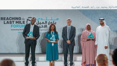 Frontline workers receive their Reach awards at the Reaching the Last Mile forum at Louvre Abu Dhabi on Tuesday. (L-R) Richard Kojan, Olivia Ngou and Rahane Lawal worked to tackle polio, Ebola and malaria. Pictured with Bill Gates and Sheikh Mohamed bin Zayed, Crown Prince of Abu Dhabi and Deputy Supreme Commander of the UAE. Victor Besa / The National