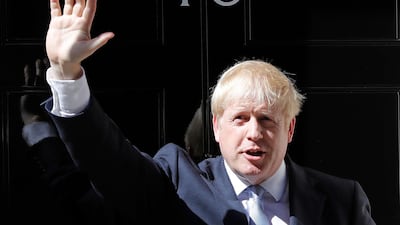 Britain's Prime Minister Boris Johnson waves from the steps outside 10 Downing Street in London. AP Photo