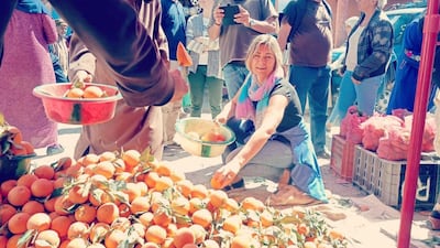 Mohammed El Arkam, Morocco: A lady is seen happily picking out oranges in the local souq of Ijjoukak in Morocco.