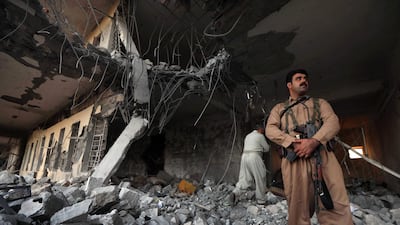Iranian Kurdish Peshmerga members of the Iranian Kurdistan Democratic Party (KDPI) check the damage after a rocket attack inside their headquarters in Koysinjaq. AFP